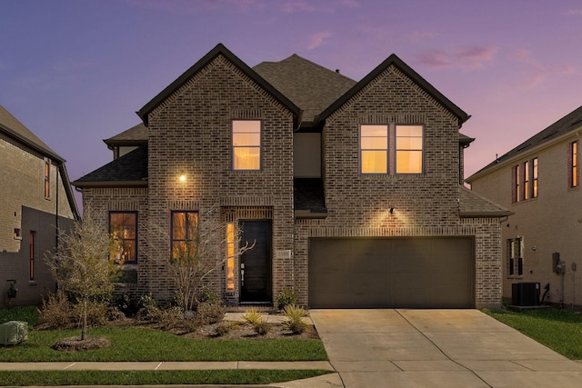 front of property with a garage and cooling unit