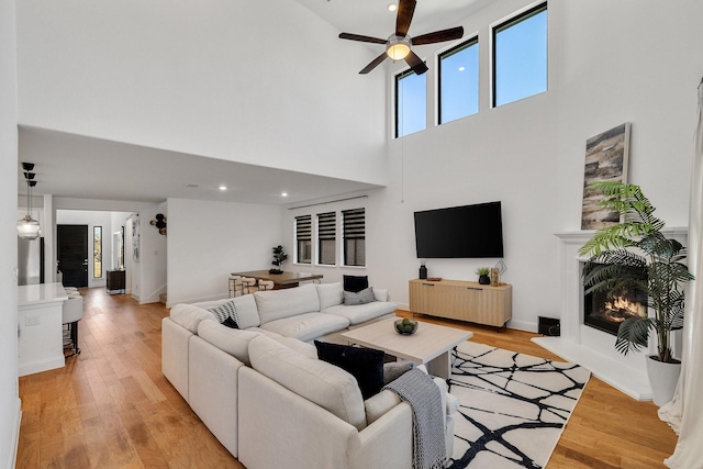 2500 Clearspring Dr, Celina, TX 75009 - living room with ceiling fan, a towering ceiling, and light wood-type flooring