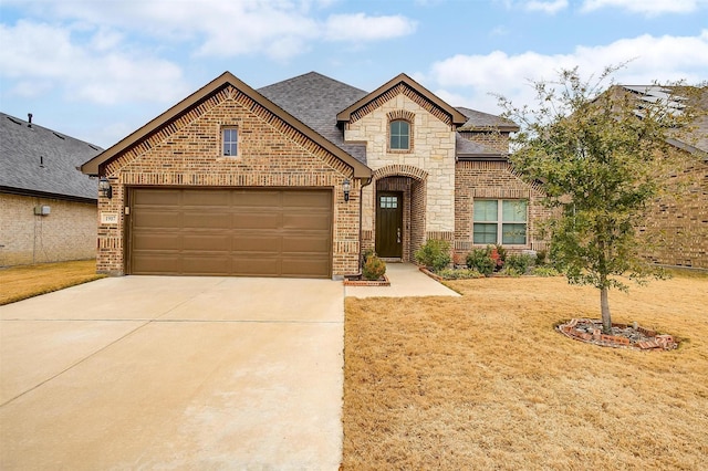 view of front of home with a garage and a front yard