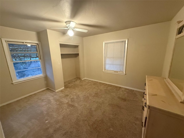 unfurnished bedroom with carpet, ceiling fan, and a closet