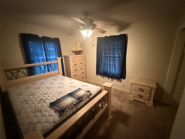 bedroom with ceiling fan and dark carpet