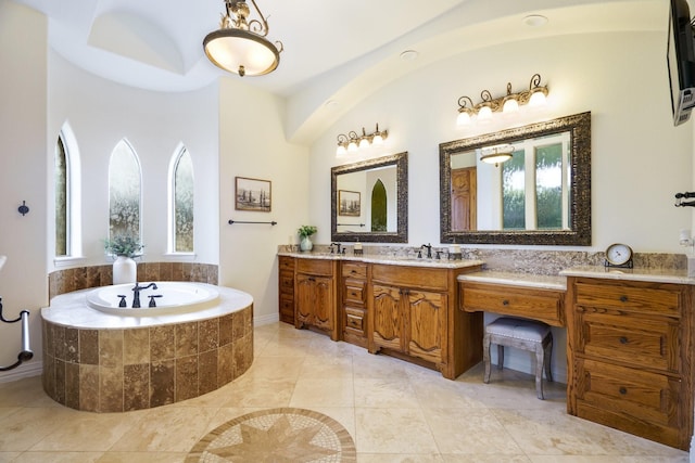 bathroom featuring vanity and tiled bath