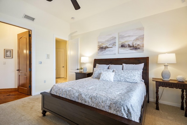 bedroom with ceiling fan and light colored carpet