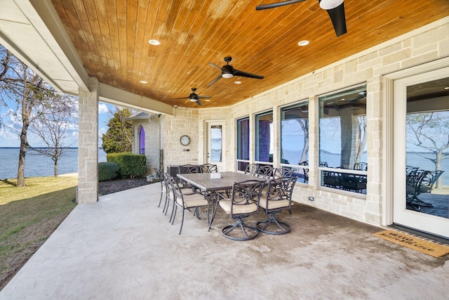 view of patio / terrace featuring a water view and ceiling fan