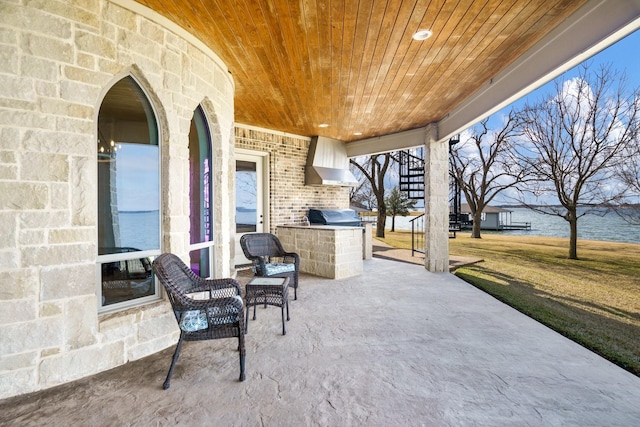 view of patio with area for grilling and a water view