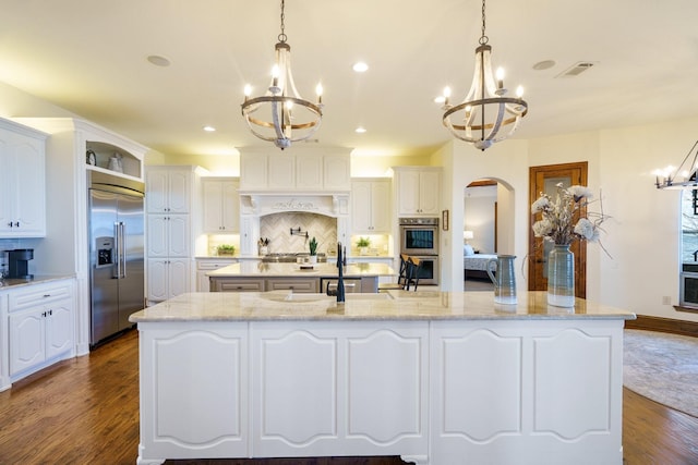 kitchen with an inviting chandelier, hanging light fixtures, and stainless steel appliances