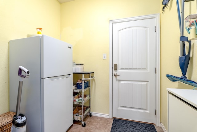 interior space with white refrigerator and light tile patterned floors