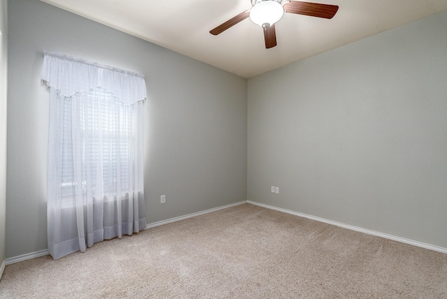 carpeted empty room featuring ceiling fan