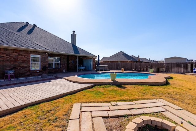 view of pool with a yard and a deck