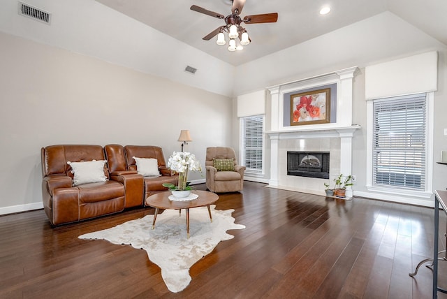 living room with ceiling fan, lofted ceiling, a fireplace, and dark hardwood / wood-style flooring