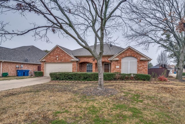 ranch-style house featuring a garage and a front yard