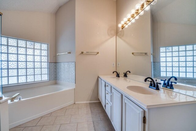 spare room featuring lofted ceiling, light carpet, a wealth of natural light, and a textured ceiling