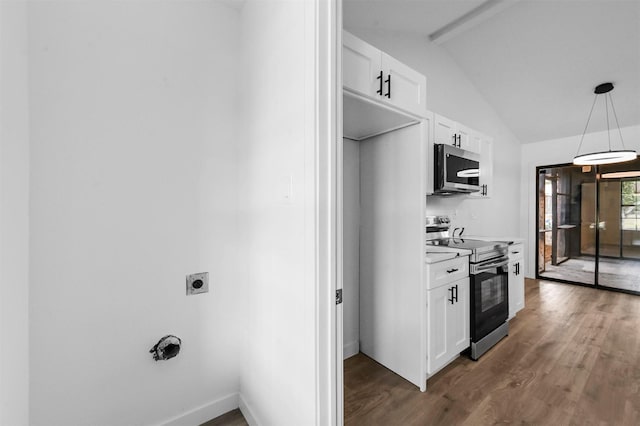 kitchen with stainless steel appliances, dark hardwood / wood-style floors, lofted ceiling with beams, white cabinets, and decorative light fixtures