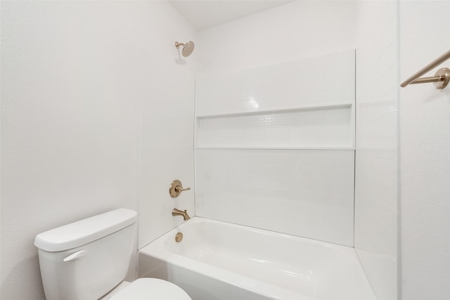 bathroom featuring toilet and tiled shower / bath combo