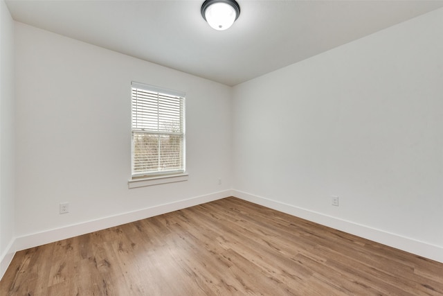 empty room with light hardwood / wood-style flooring