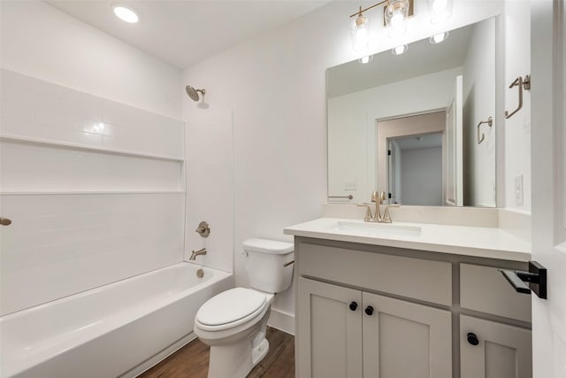 full bathroom with toilet, hardwood / wood-style floors, vanity, and  shower combination