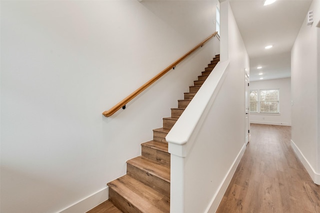 stairs with hardwood / wood-style flooring