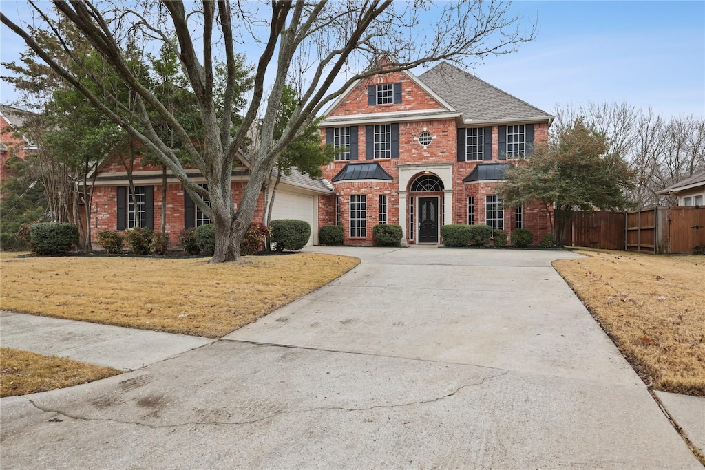 view of front facade featuring a garage and a front lawn