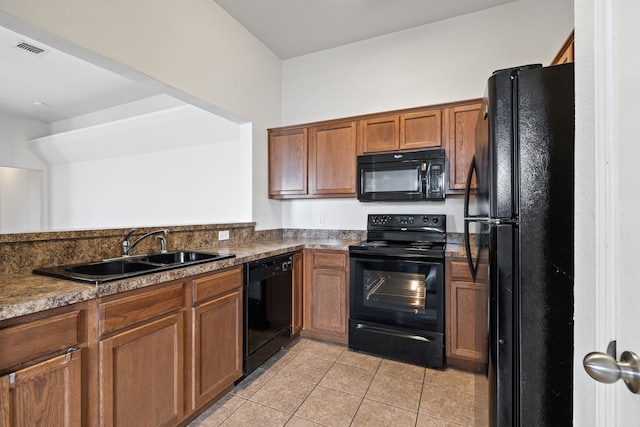 kitchen with sink, light tile patterned floors, and black appliances