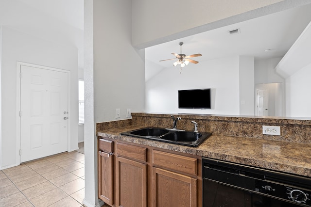 kitchen featuring lofted ceiling, sink, ceiling fan, black dishwasher, and light tile patterned flooring