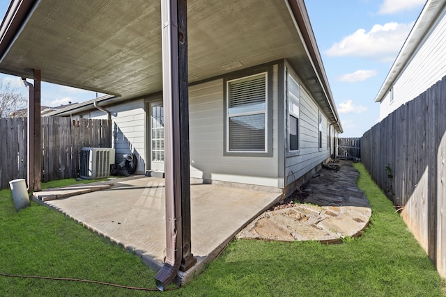 exterior space featuring a lawn, central AC unit, and a patio area