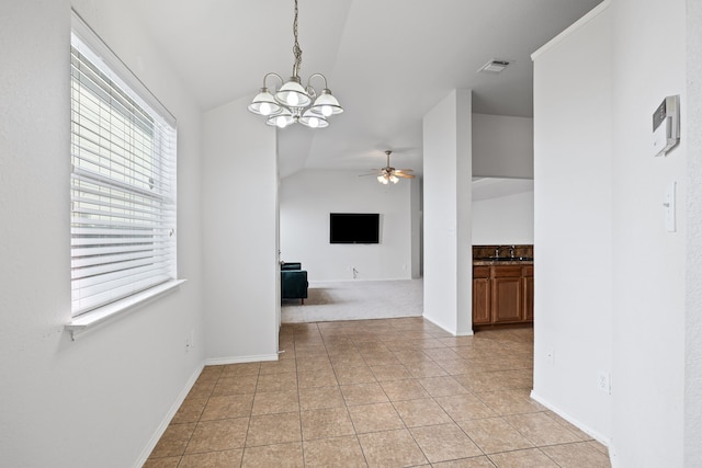 interior space with ceiling fan with notable chandelier, lofted ceiling, and sink