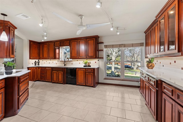 kitchen with sink, backsplash, hanging light fixtures, ceiling fan, and black appliances