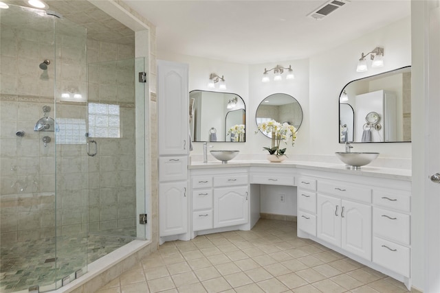 bathroom with vanity, tile patterned flooring, and a shower with door