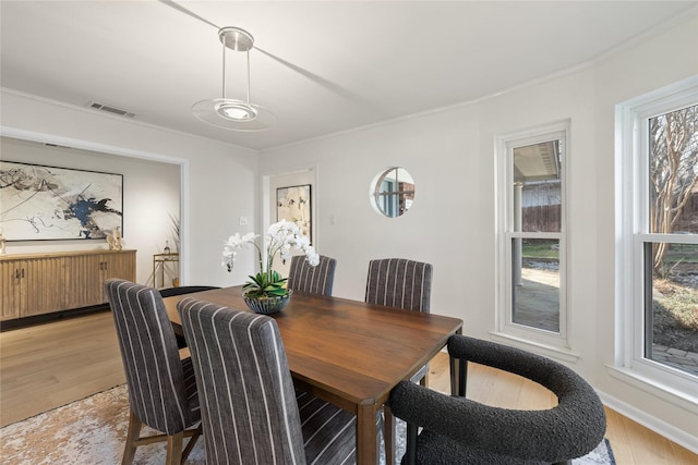 dining space with light wood-type flooring