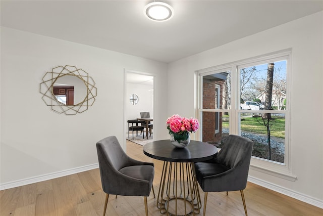 dining space with light hardwood / wood-style floors