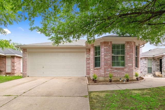 4302 Comer St, Denton, TX 76207 - view of front of property with concrete driveway, an attached garage, and brick siding
