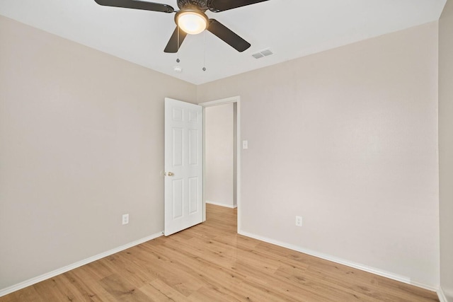 spare room featuring light hardwood / wood-style floors and ceiling fan