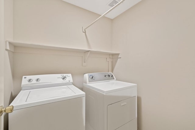 washroom with independent washer and dryer