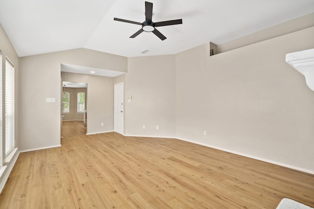 empty room with ceiling fan, lofted ceiling, and light hardwood / wood-style floors