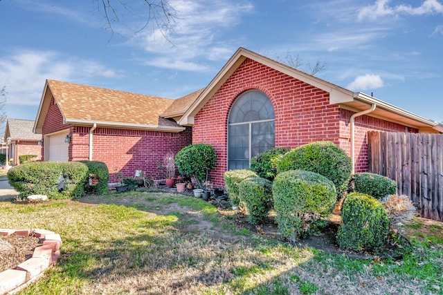 view of front facade with a garage and a front yard