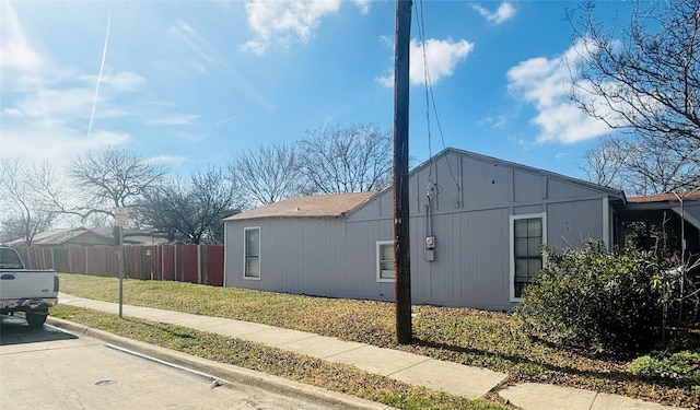 view of side of home with fence