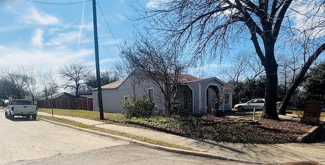 view of property exterior featuring fence