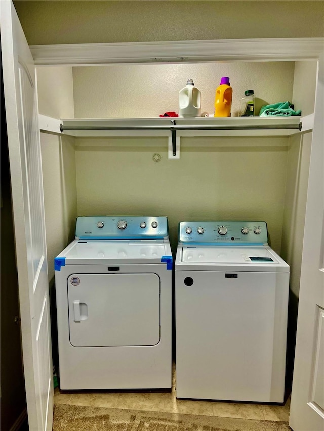 laundry area featuring washing machine and clothes dryer