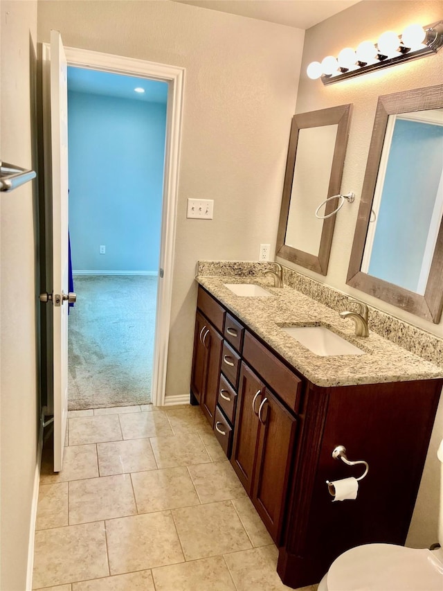 bathroom with vanity, tile patterned flooring, and toilet