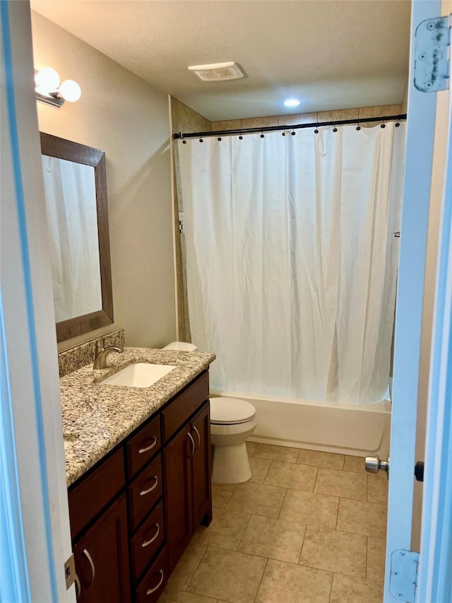 full bathroom featuring vanity, shower / bath combo, and toilet