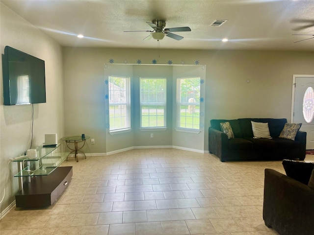 living room featuring light tile patterned floors and ceiling fan