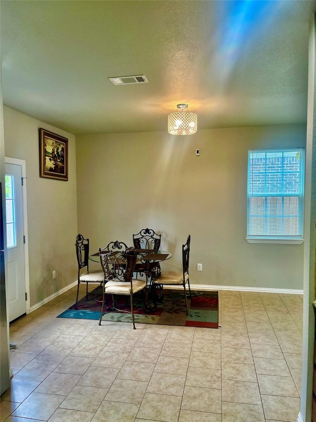 dining room with light tile patterned floors and plenty of natural light