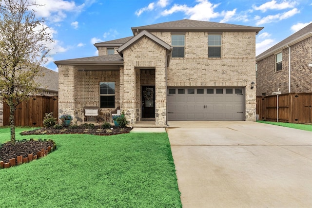 view of front of house featuring a front yard, fence, brick siding, and driveway