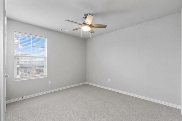 empty room with ceiling fan and carpet flooring