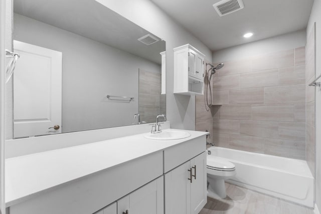 bathroom featuring vanity, toilet, tub / shower combination, and visible vents