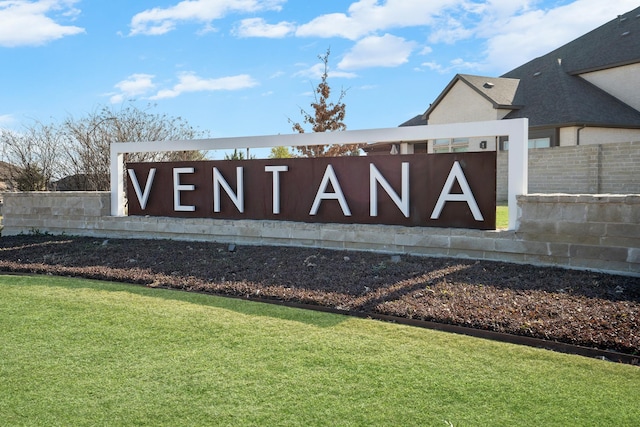 community sign with a yard and fence