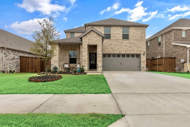 view of front of property featuring a garage and a front lawn