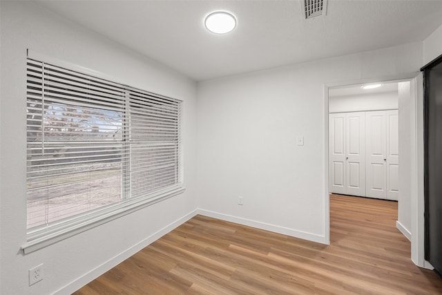 spare room featuring hardwood / wood-style flooring