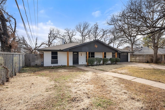 ranch-style house with a garage and a front yard