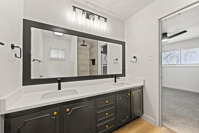 bathroom with walk in shower, vanity, wood-type flooring, and a textured ceiling